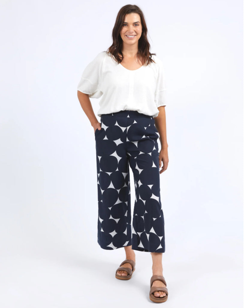 Step out in style with the Demi Spot Pant, featuring a bold navy spot print exclusive to Elm. Designed for effortless elegance