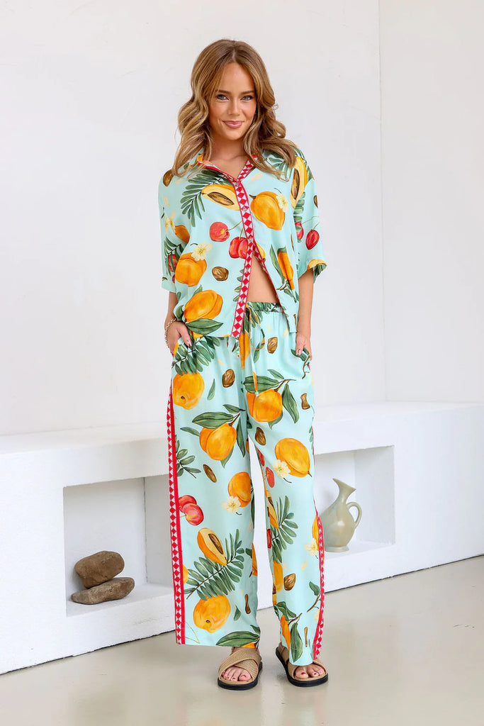 Dress for sunny days in style with our Fruit Pants! Made with a playful tropical fruit print, these pants are perfect for both vacations and everyday wear. Pair