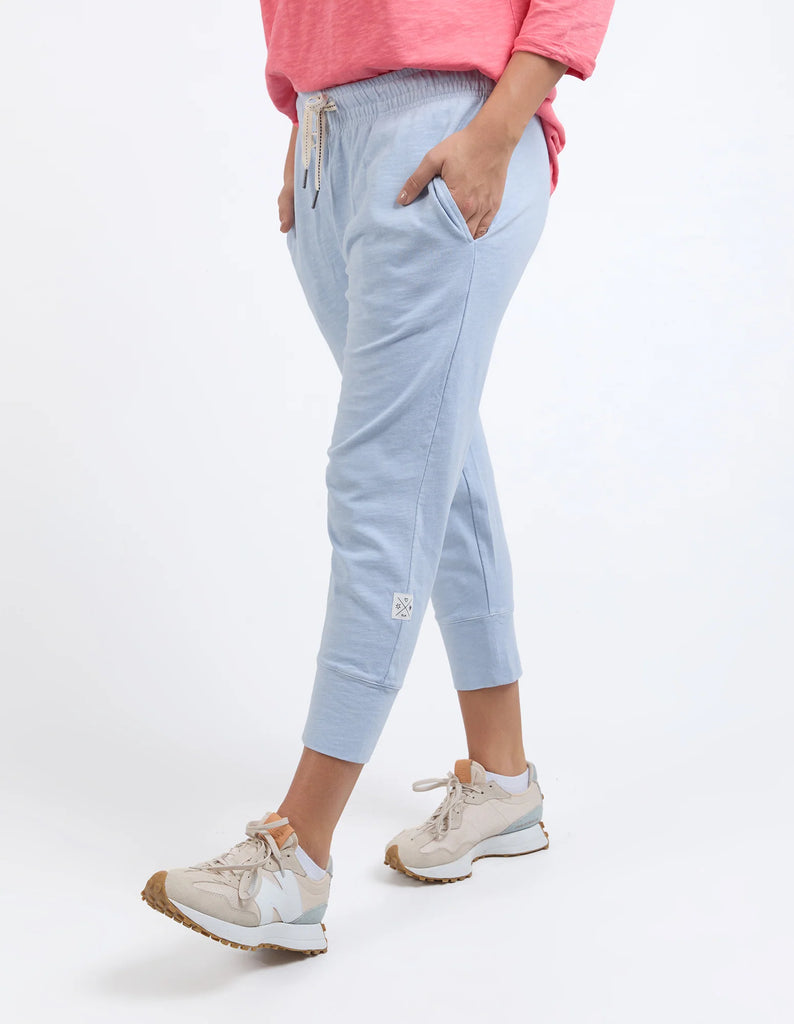 Light blue jogger pants worn by a person on a white background