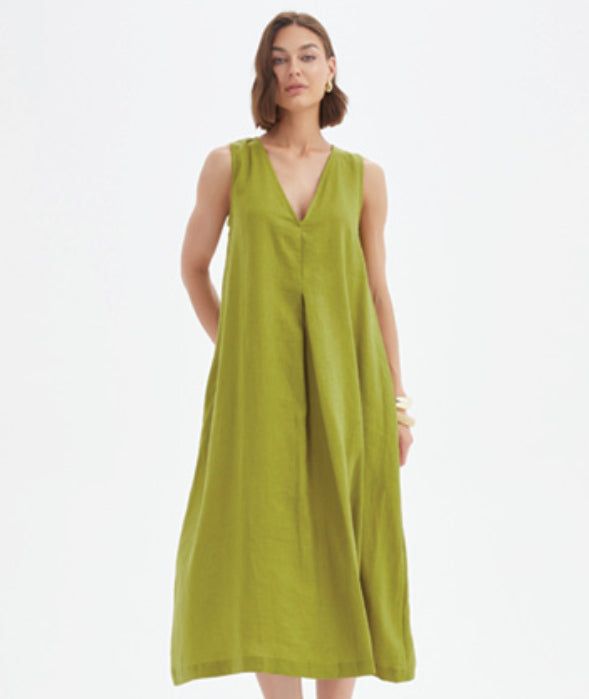 Woman wearing a green sleeveless dress on a white background