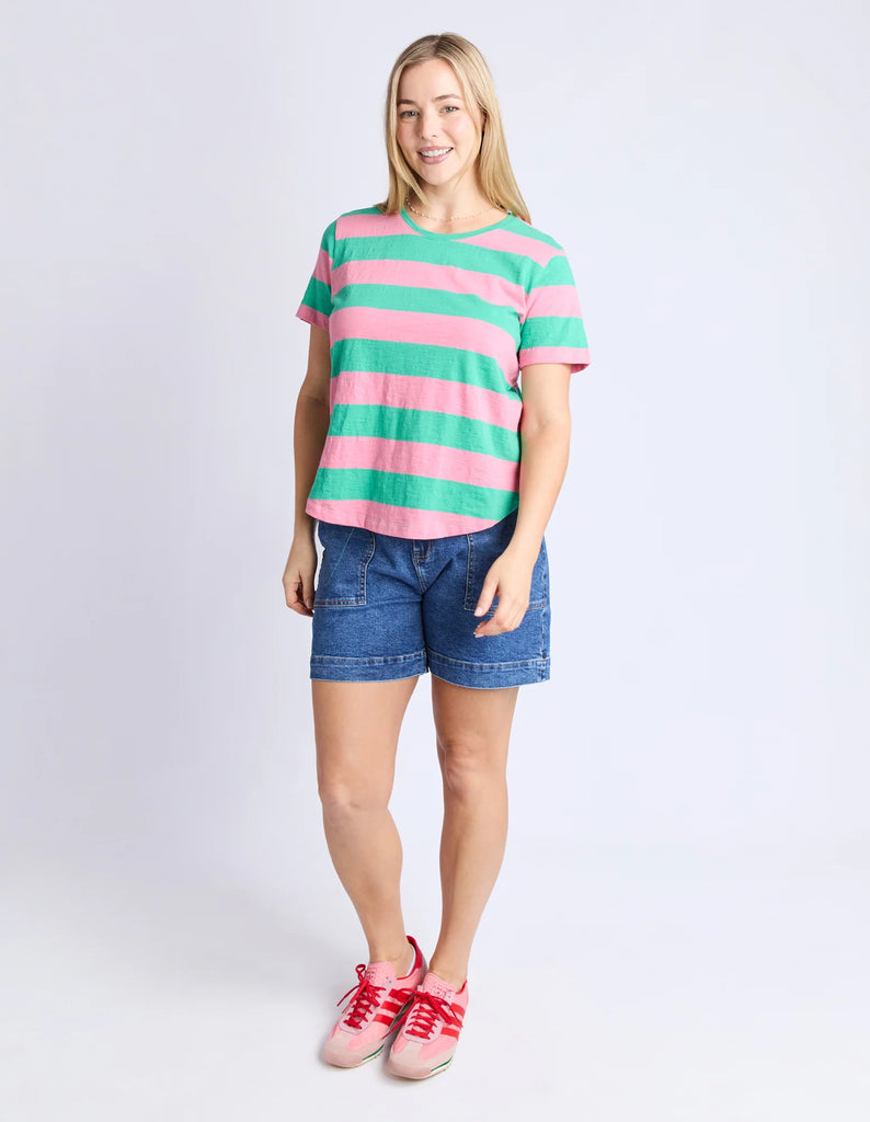 Woman wearing a striped shirt and denim shorts on a white background