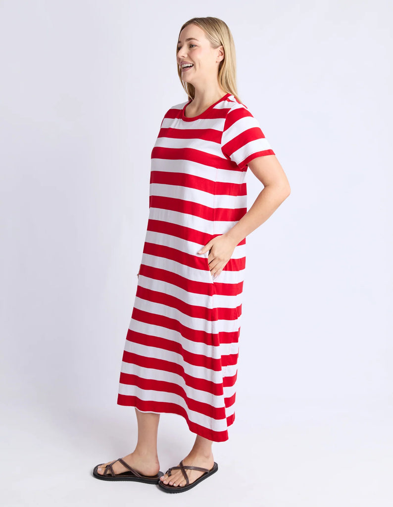 Woman wearing a red and white striped dress on a plain background