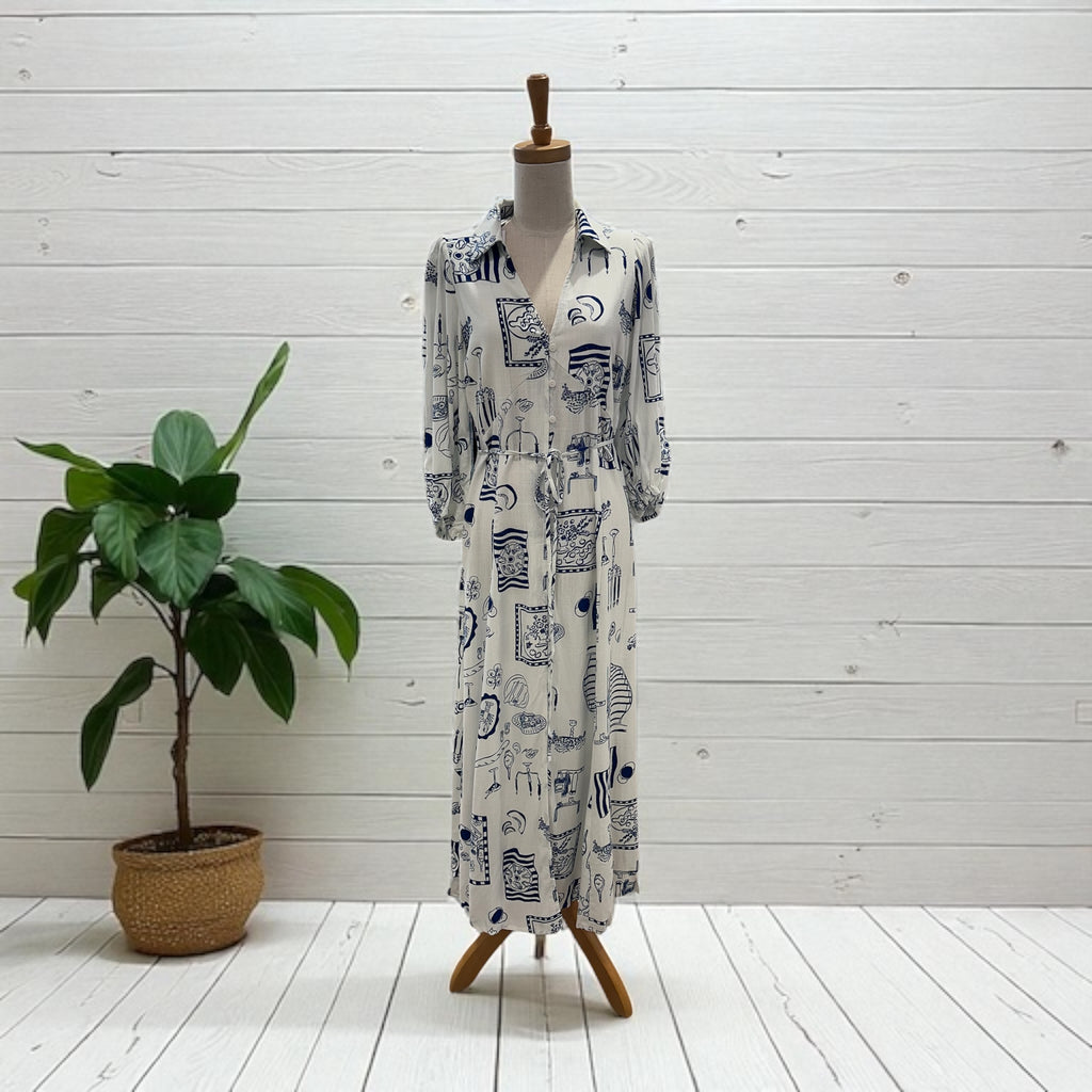 Long dress with a pattern on a mannequin against a white wooden panel background