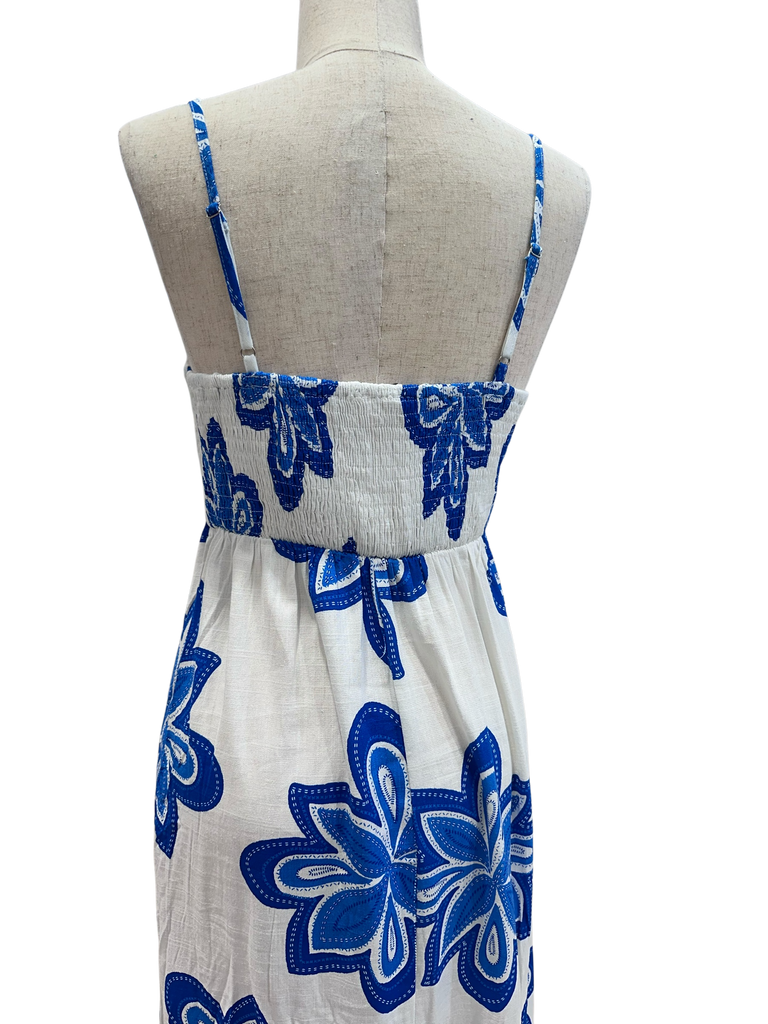 White dress with blue floral patterns on a mannequin against a white background
