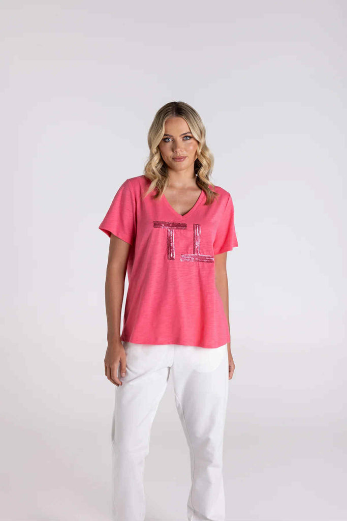 Woman wearing a pink t-shirt with text on a white background