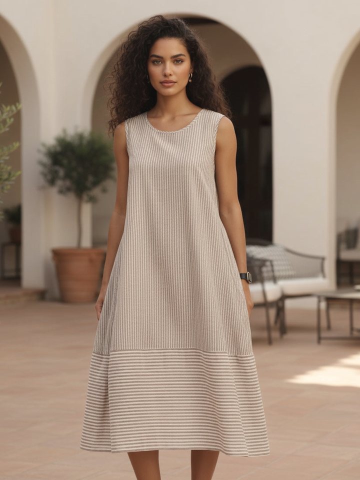 Tirelli sleeveless tie belt dress in a sandstone courtyard